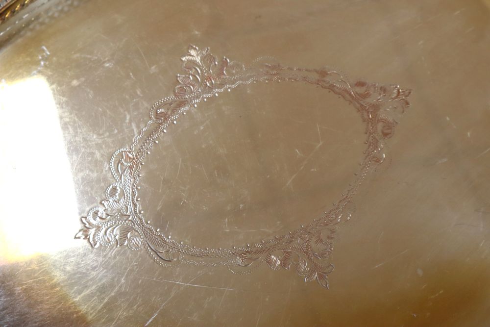 An oval two handled plated tray on lion paw feet, and another tray, largest 57cm